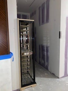 A room with walls and a door open to the kitchen.