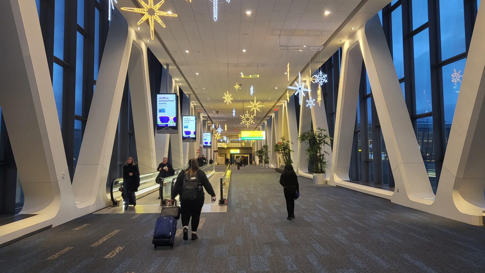 People walking through an airport terminal.