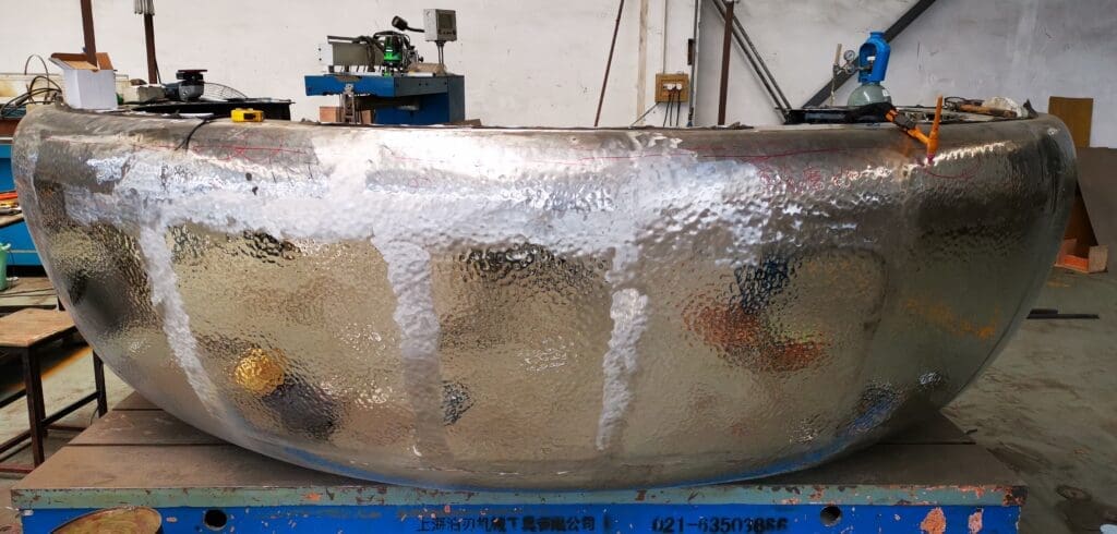 A large metal bowl sitting on top of a table.