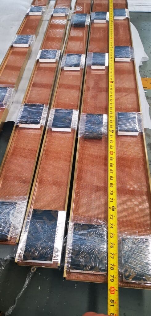 A tape measure is on top of some wood.