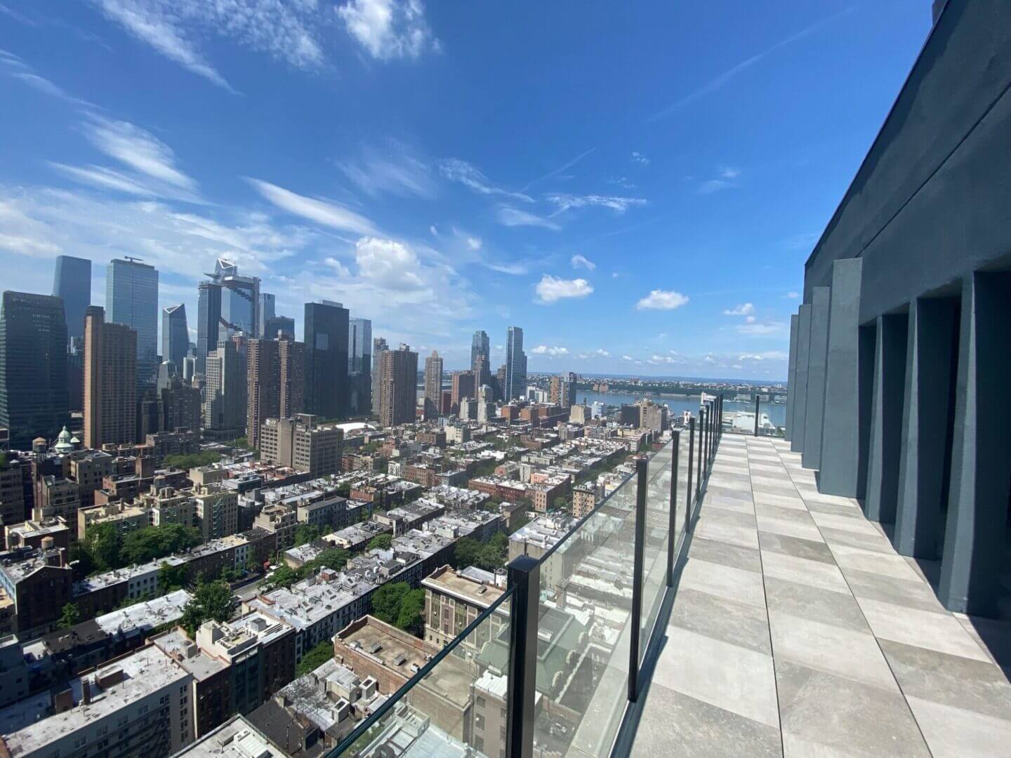 A view of the city from an glass railing balcony