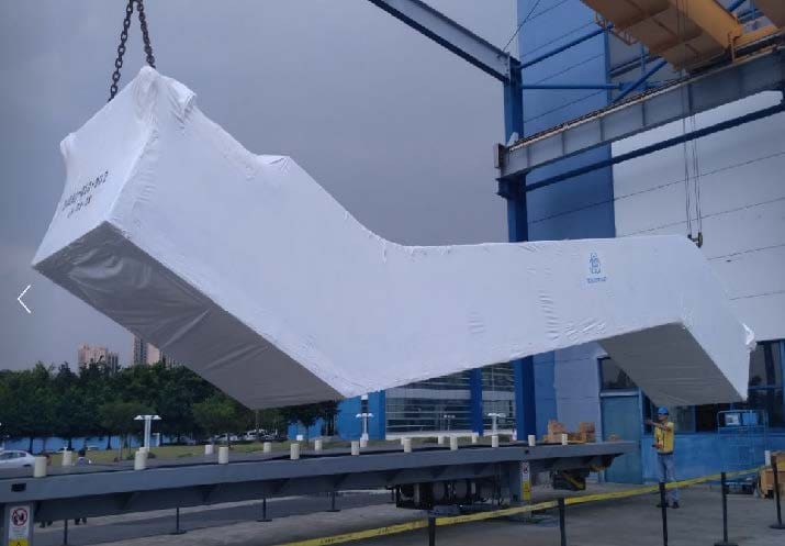 A large white object hanging from the side of a building.
