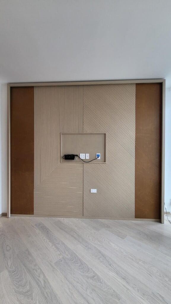 Modern wall design with textured panels and a hidden TV mount.